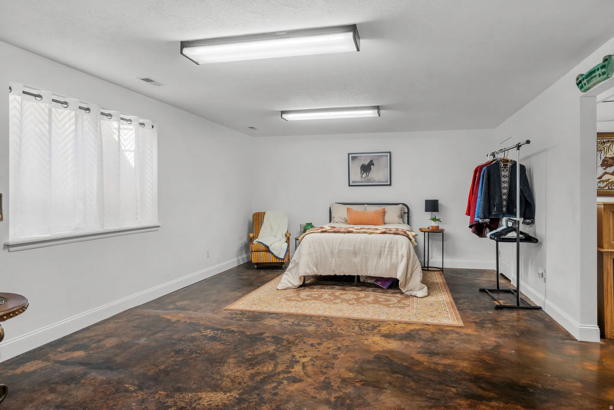 basement family room with polished stained concrete floors