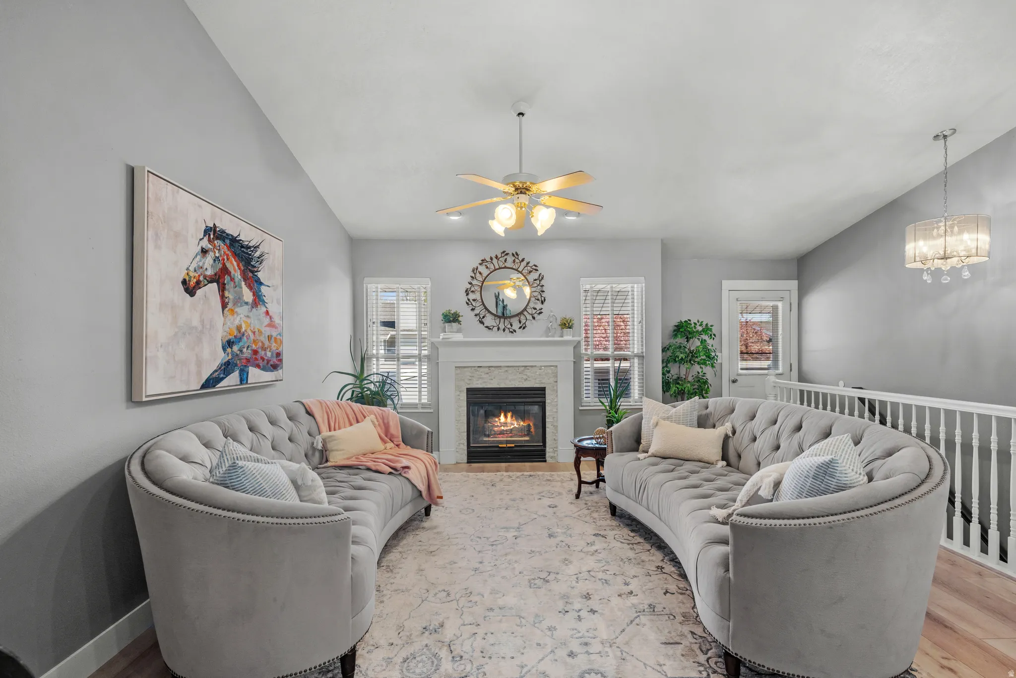Living area featuring a fireplace with a white mantel, light gray walls, and LVP flooring