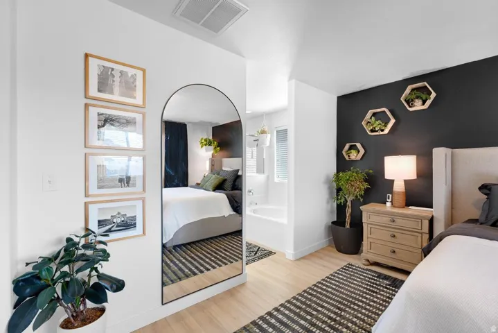 Light wood-finish flooring with a striped area rug