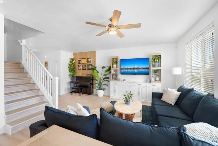 Bright living area featuring wood-finish flooring and white walls