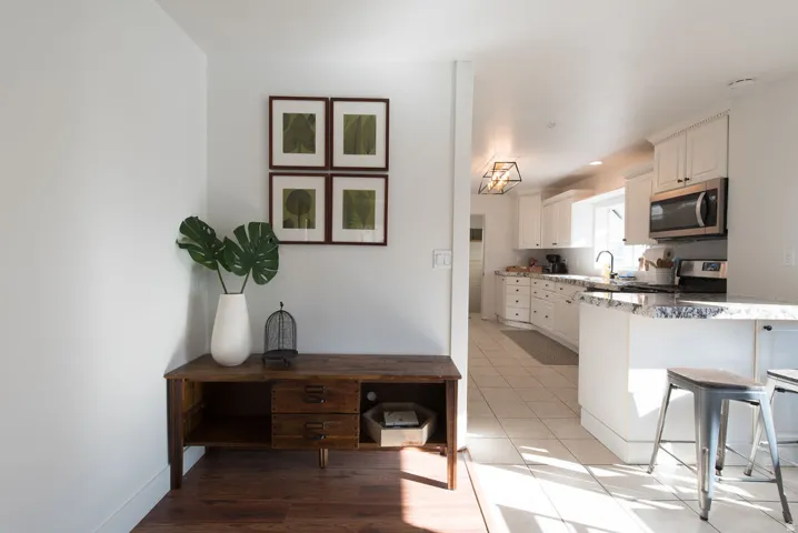 Kitchen featuring white cabinetry, stainless steel appliances, and a light-toned tile floor