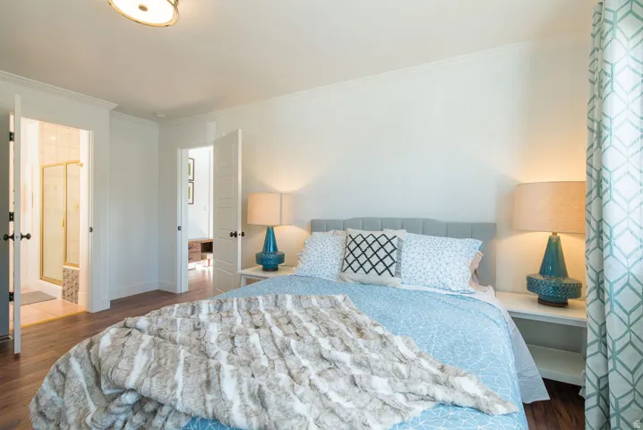 Bright interior space featuring wood-finish flooring, white walls, and crown molding