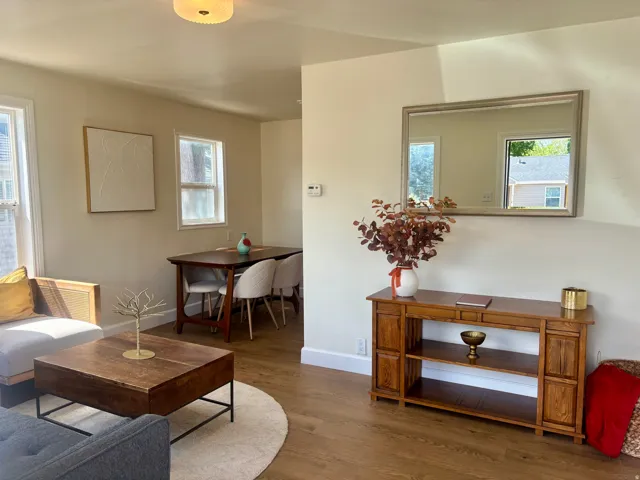 Open concept living area with wood-finish flooring
