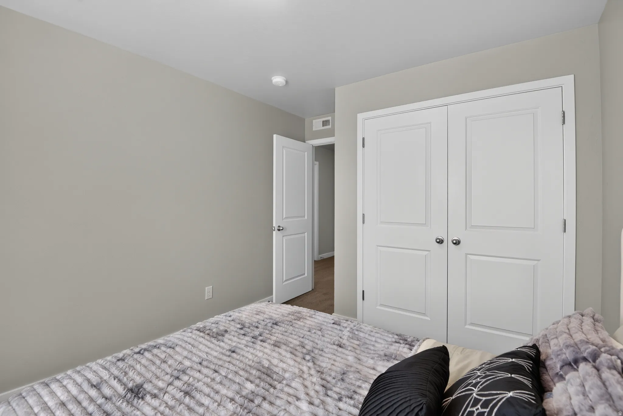 Bedroom featuring neutral wall paint, white trim, and a ceiling-mounted light fixture