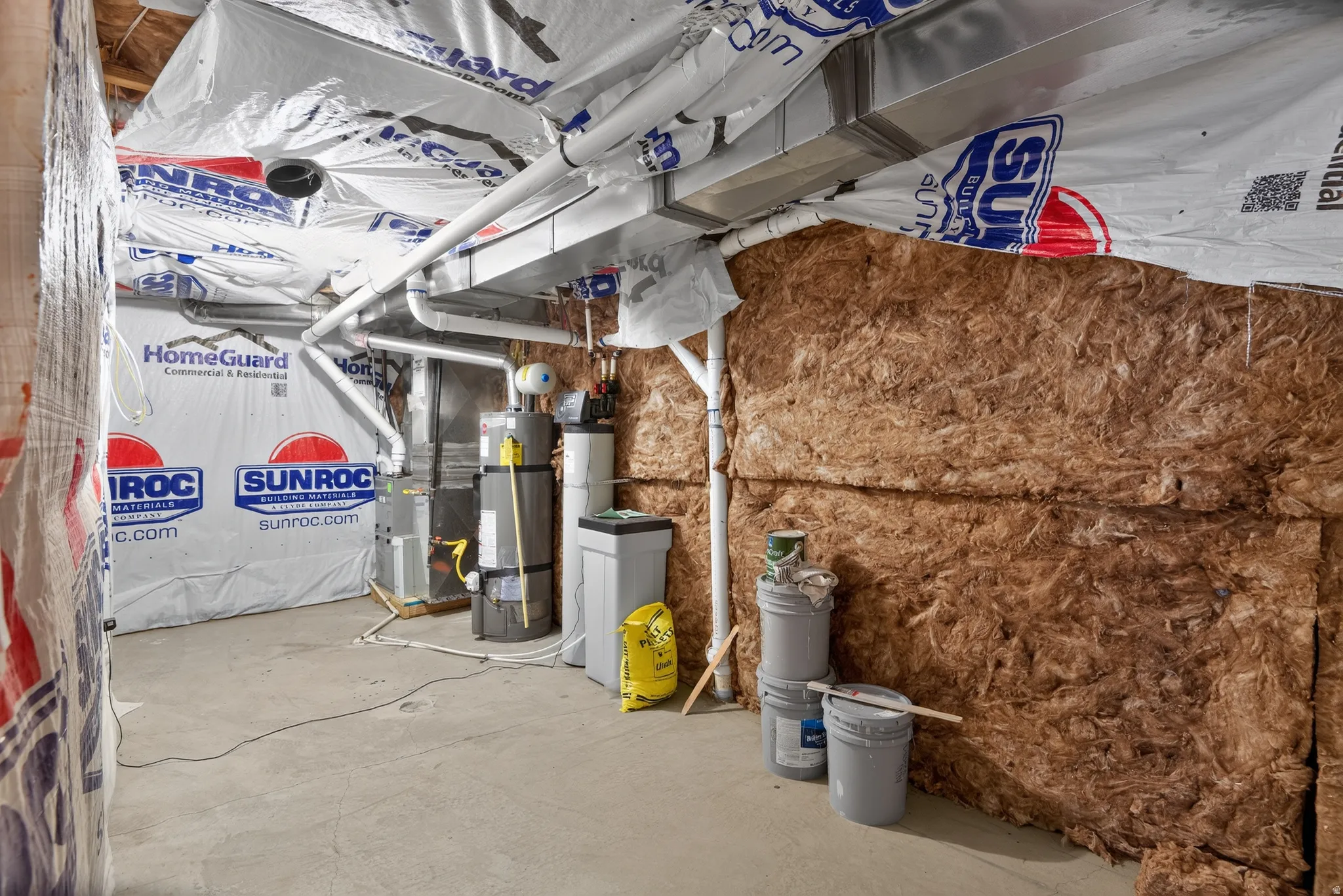 Unfinished basement area featuring exposed insulation and utility infrastructure