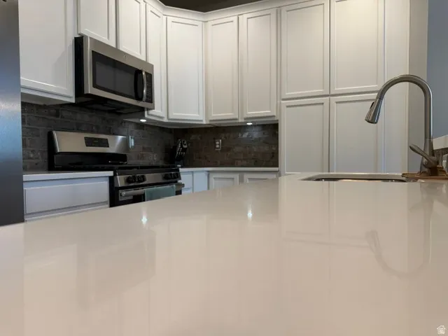Spacious kitchen island with a built-in sink and gooseneck faucet