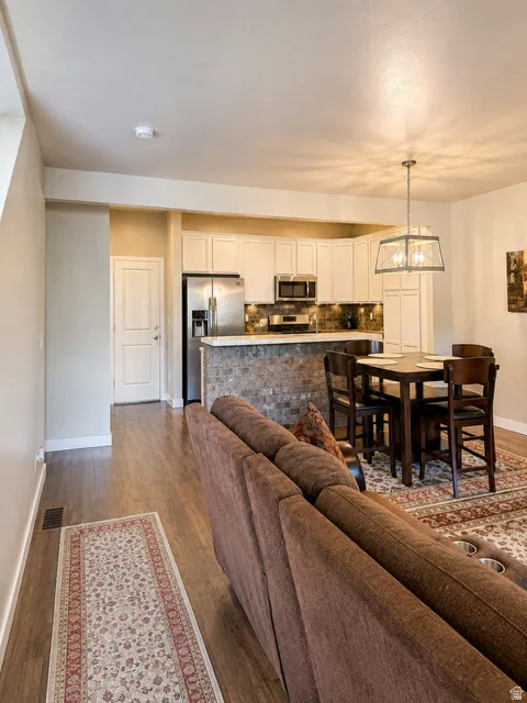 Open-concept kitchen and dining area with wood-finish flooring