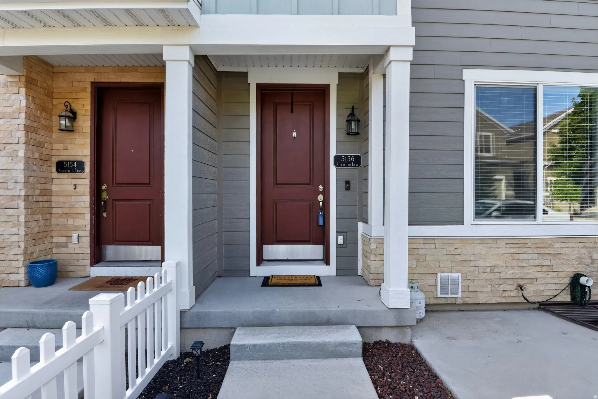 Contemporary facade featuring horizontal siding and stone veneer accents