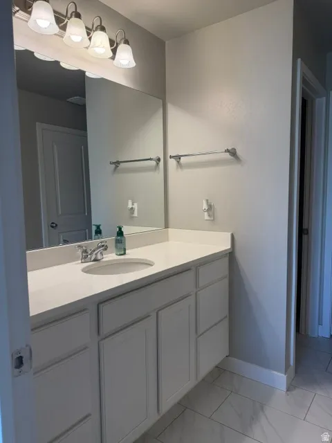 Spacious bathroom vanity featuring a white countertop with integrated sink