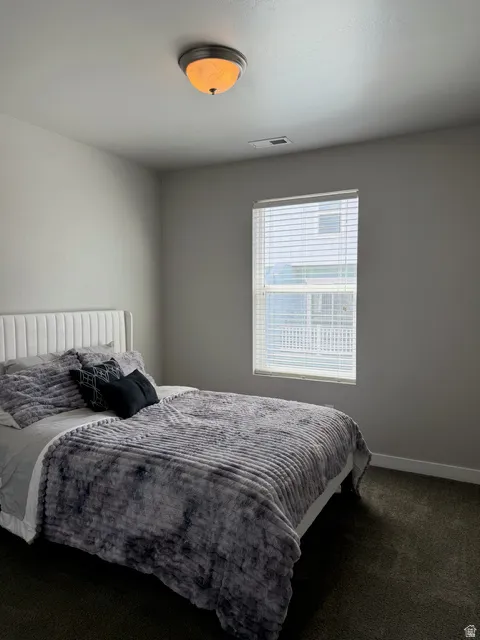 Neutral wall tones with a window featuring horizontal blinds