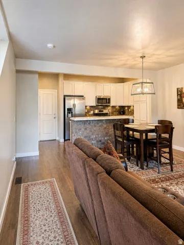 Open-concept kitchen and dining area with wood-finish flooring