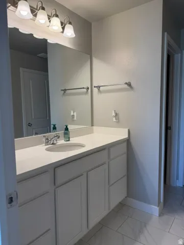 Spacious bathroom vanity featuring a white countertop with integrated sink