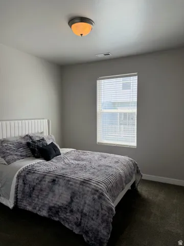 Neutral wall tones with a window featuring horizontal blinds