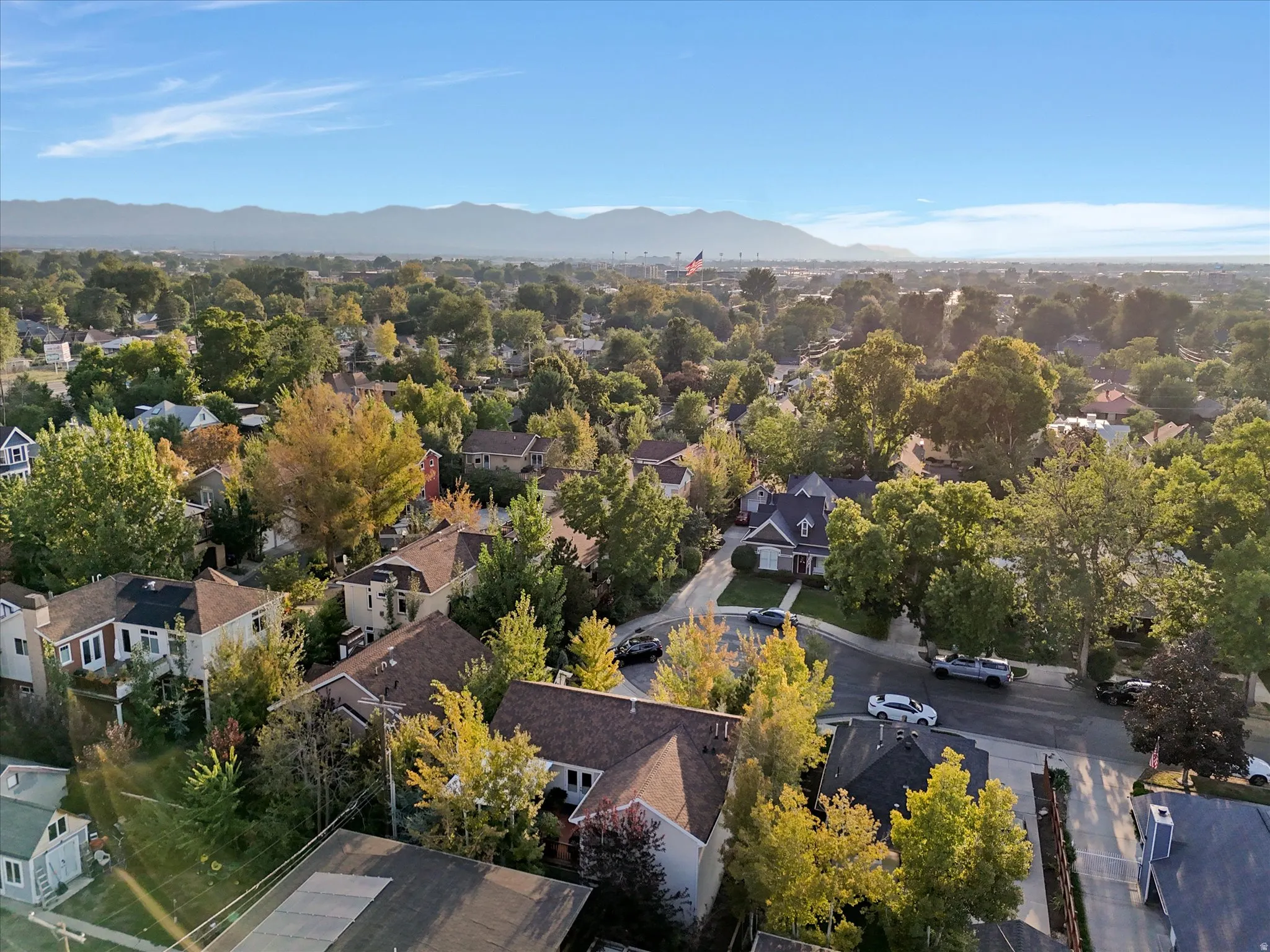 Aerial perspective of suburban area with a mountainous background