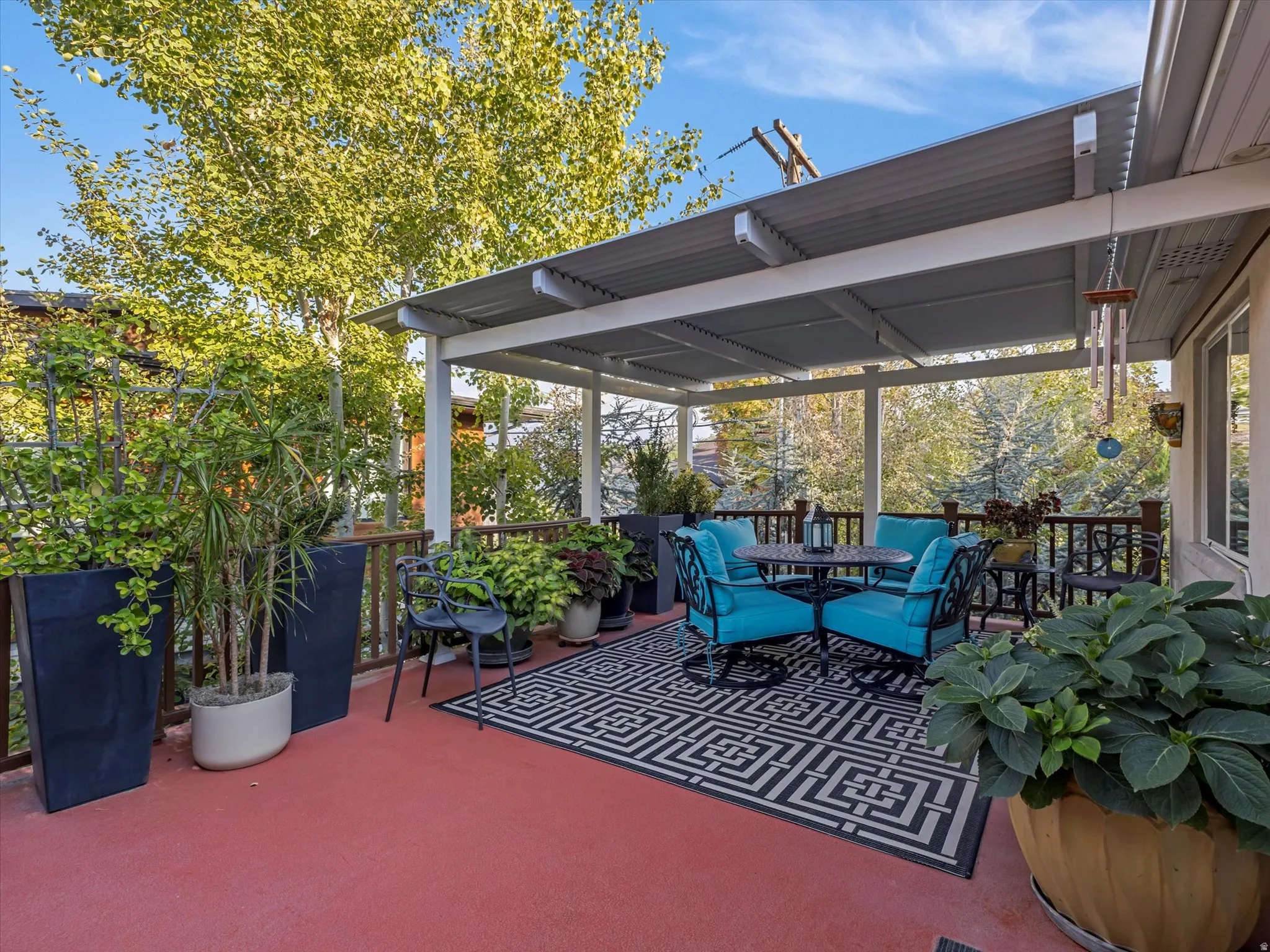 View of deck with outdoor dining space, cover and a view