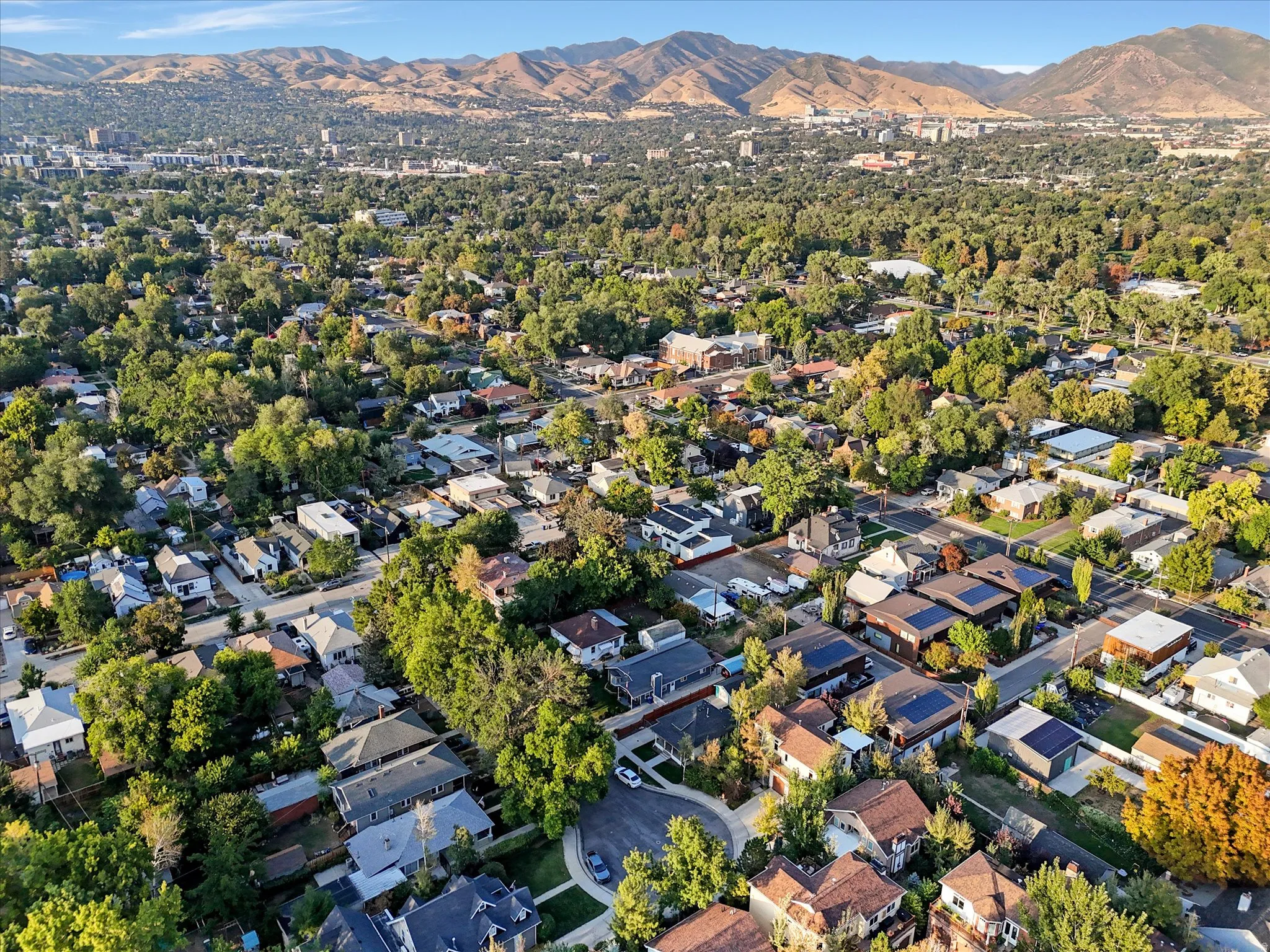 Aerial overview of property's location with a mountain backdrop and nearby suburban area