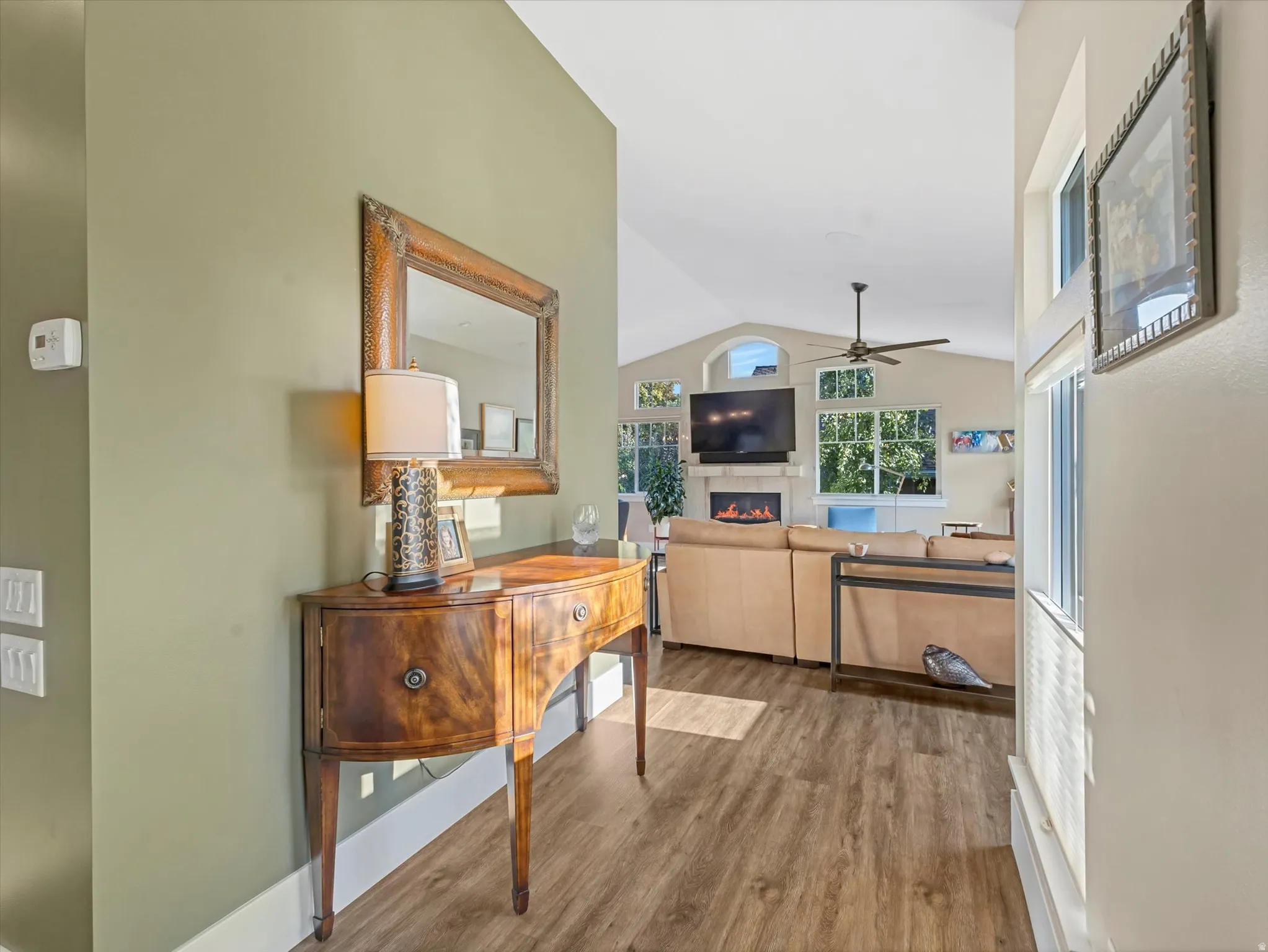 Corridor with vaulted ceiling and wood finished floors