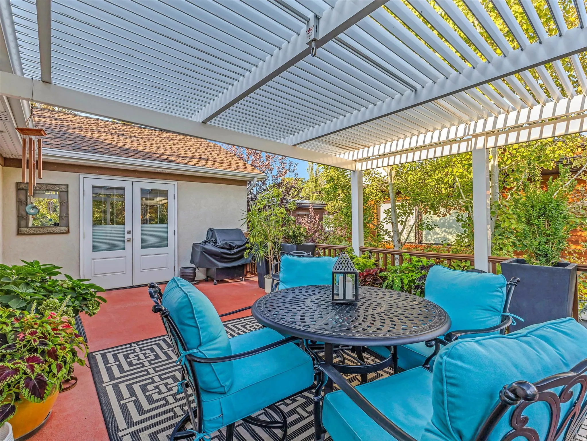 View of deck with french doors, grilling area, and outdoor dining area and a view