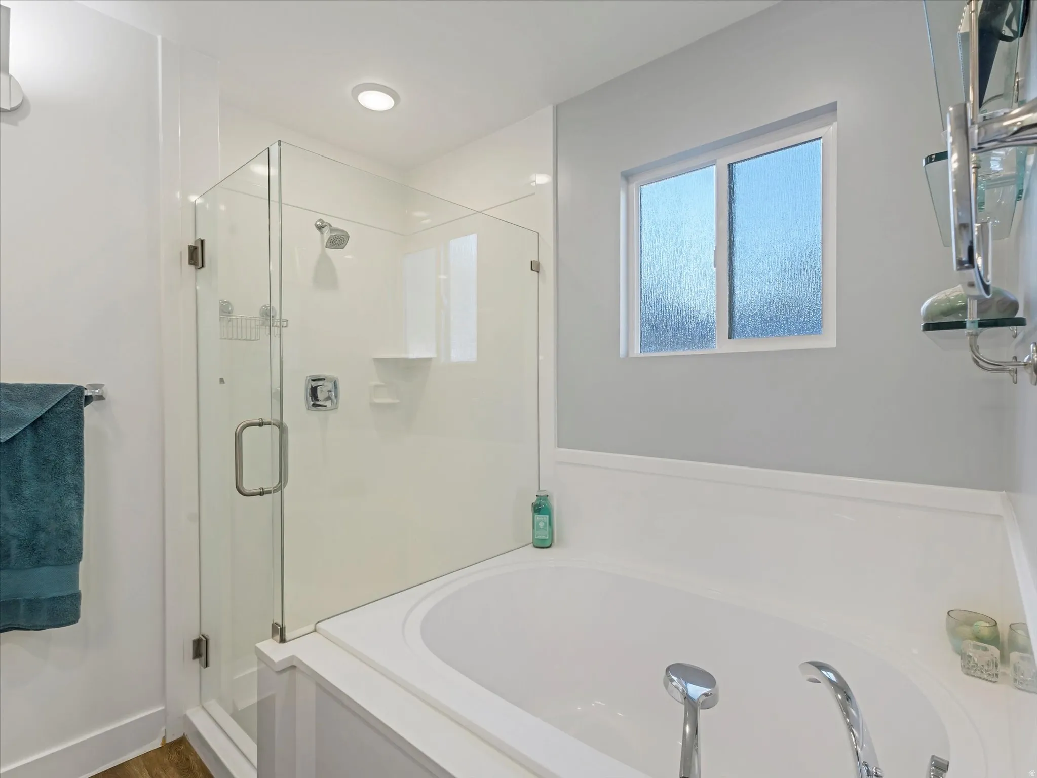 Bathroom with a bath and a stall shower