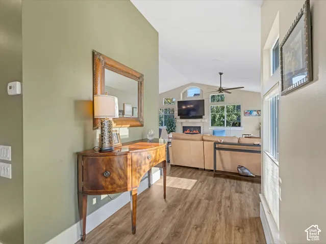 Corridor with vaulted ceiling and wood finished floors