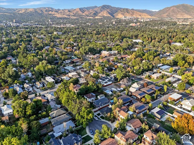 Aerial overview of property's location with a mountain backdrop and nearby suburban area