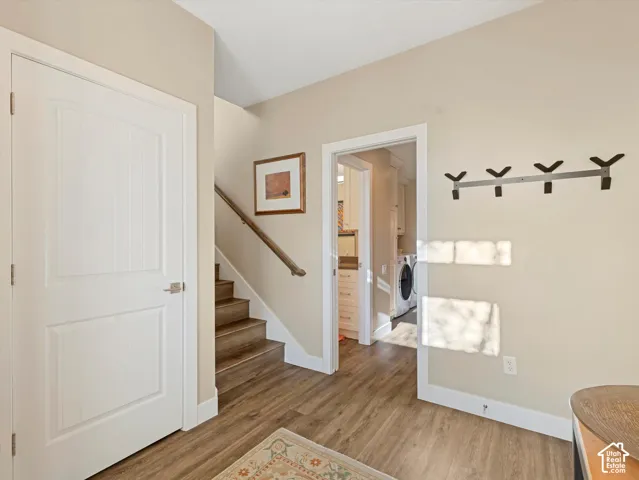 Mudroom featuring light wood-style floors and washer / clothes dryer