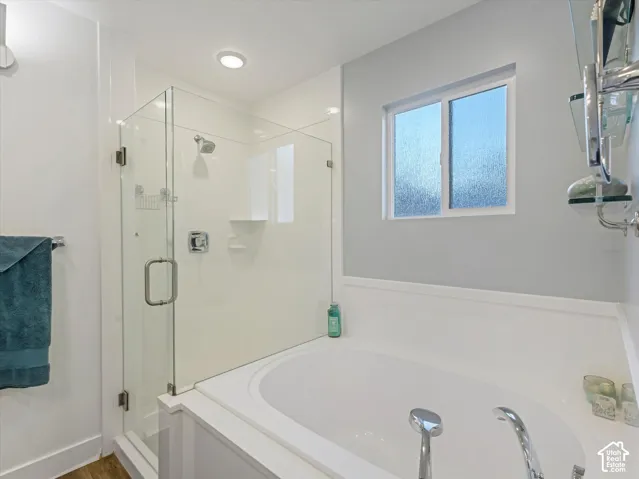 Bathroom with a bath and a stall shower