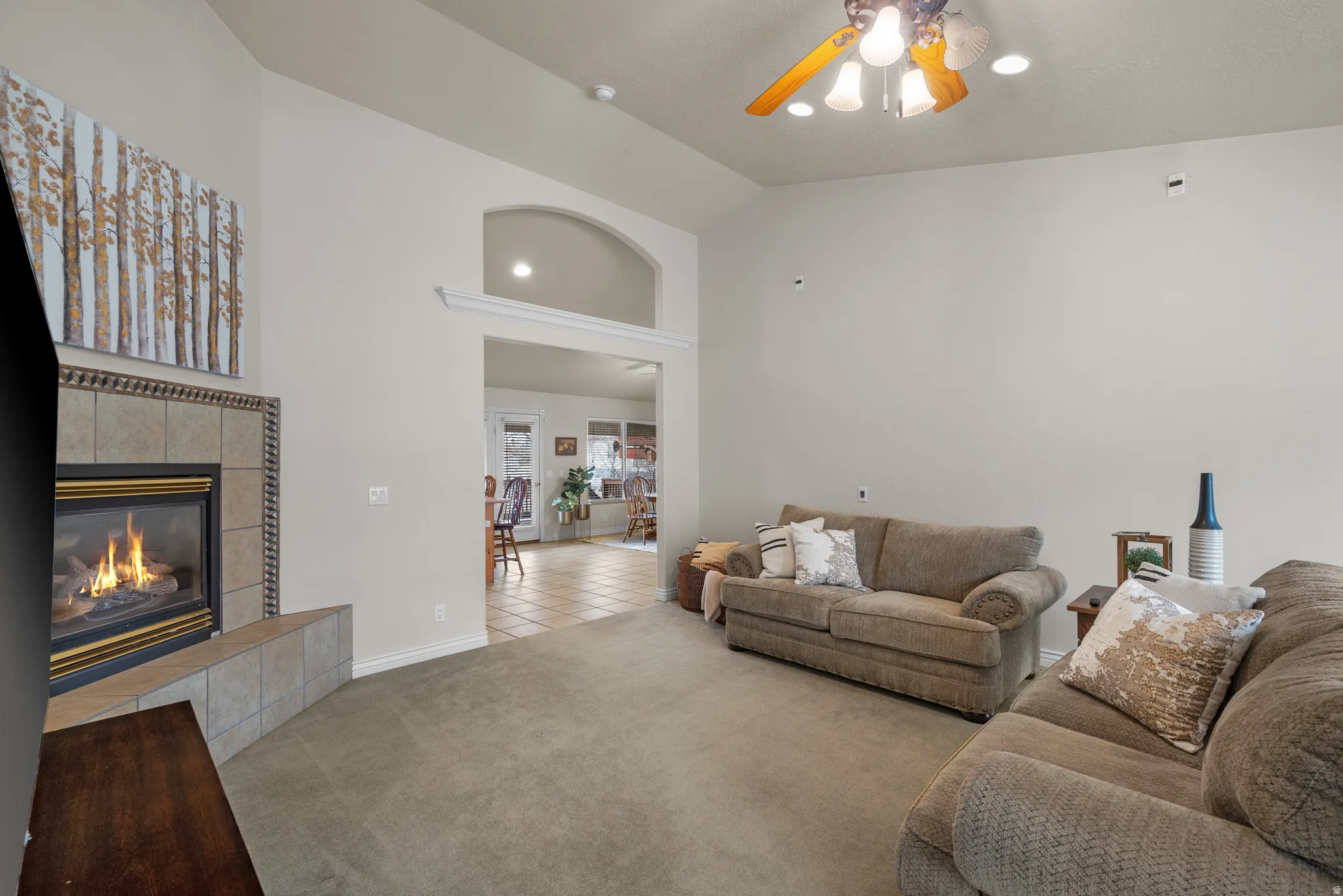 Open living space featuring vaulted ceilings and recessed lighting