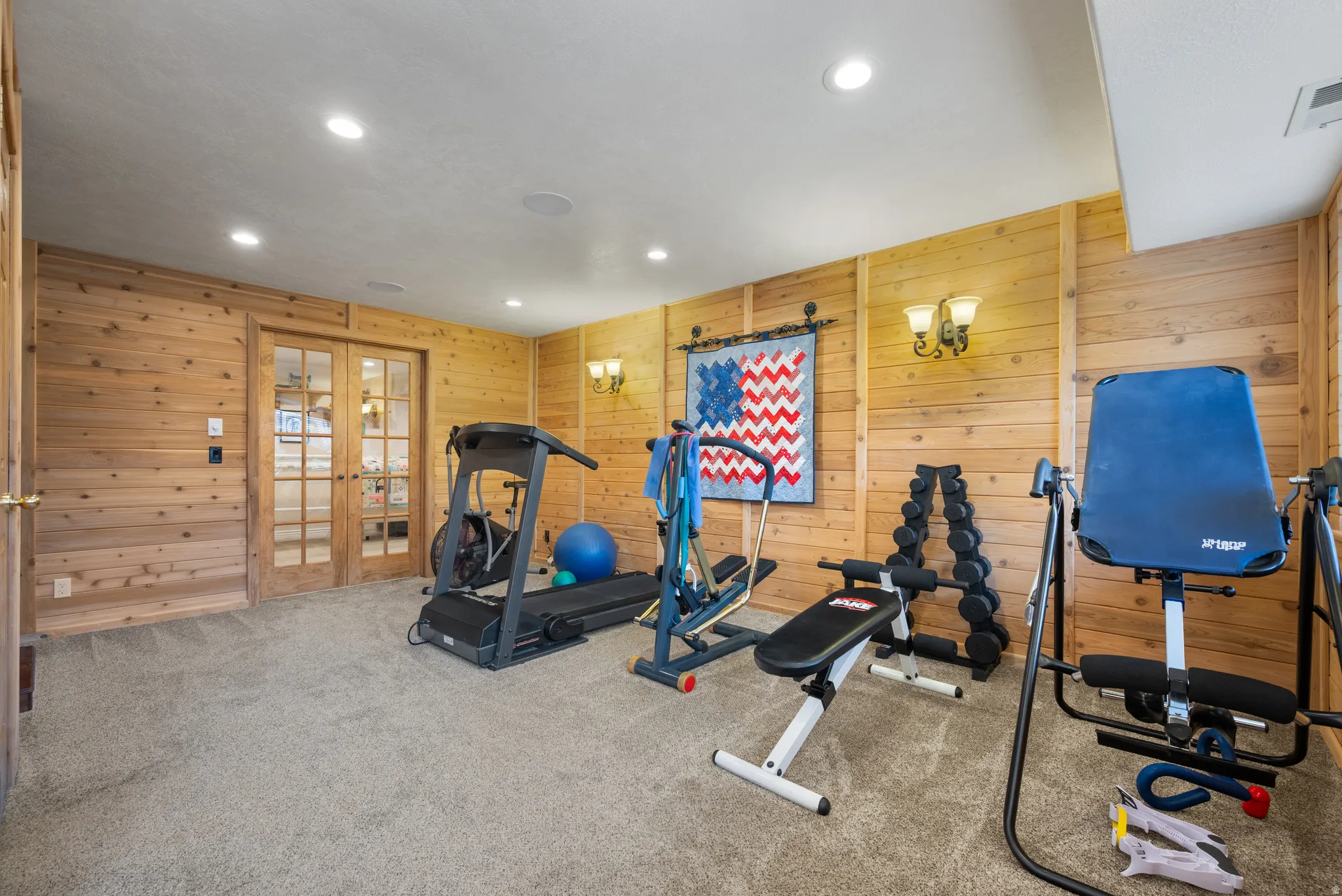 Basement workout room or family gathering space with wood paneled walls
