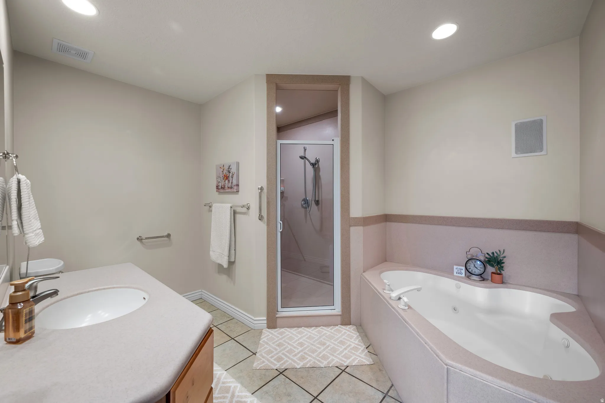 Primary bathroom with walk in shower and large soaking tub