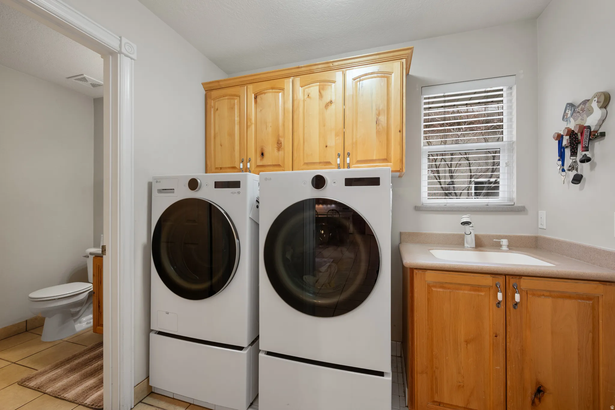 Laundry/ mudroom with built in cabinets and a sink