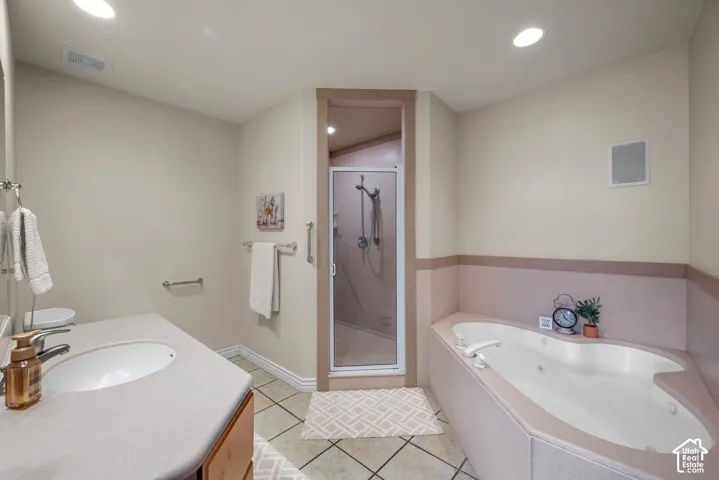 Primary bathroom with walk in shower and large soaking tub