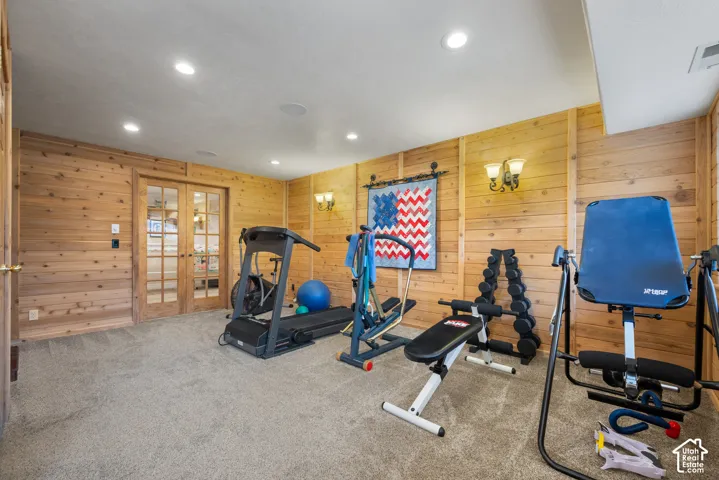 Basement workout room or family gathering space with wood paneled walls