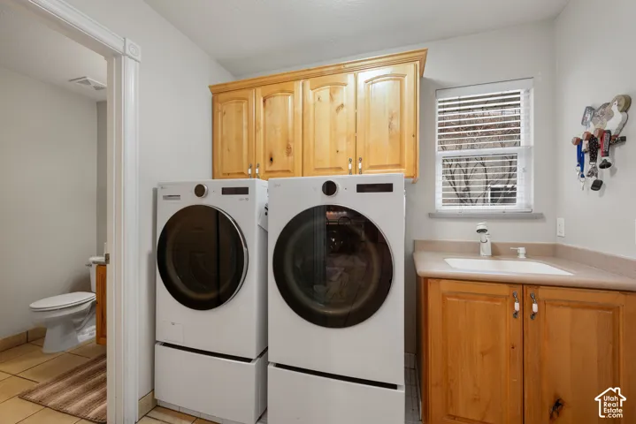 Laundry/ mudroom with built in cabinets and a sink