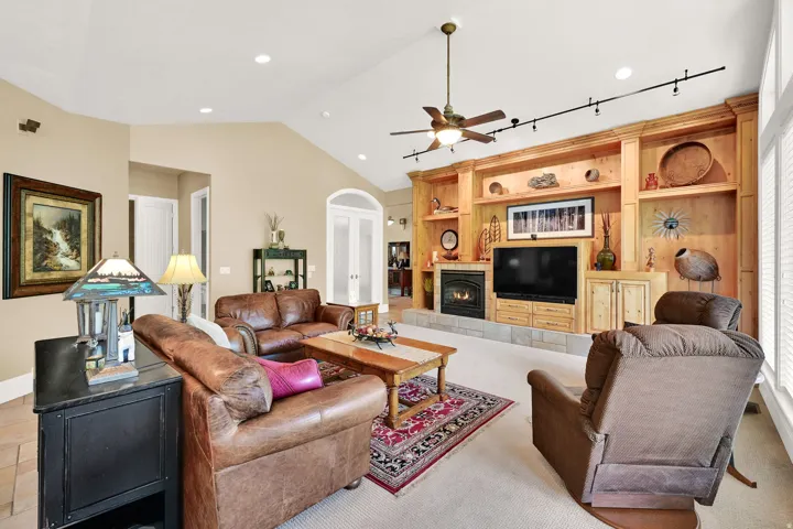 Finely crafted built-in entertainment center, fireplace, and track lighting.