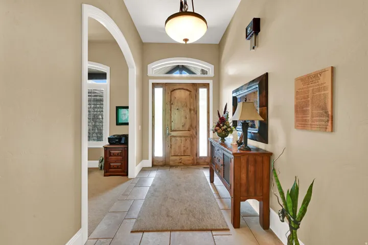 Inviting entryway with a window framed front door.