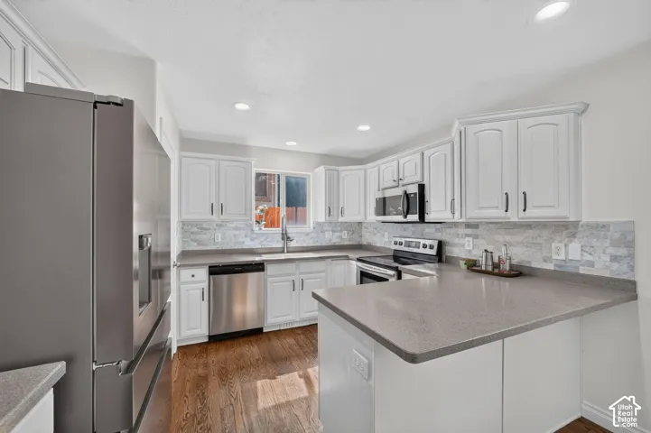 Modern kitchen with white cabinetry and dark hardware