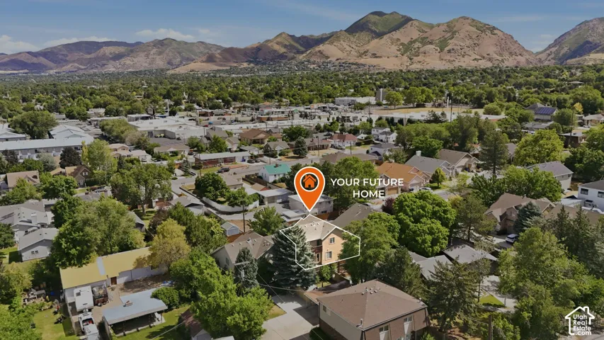 Aerial view showcasing a residential area with a prominent mountain backdrop