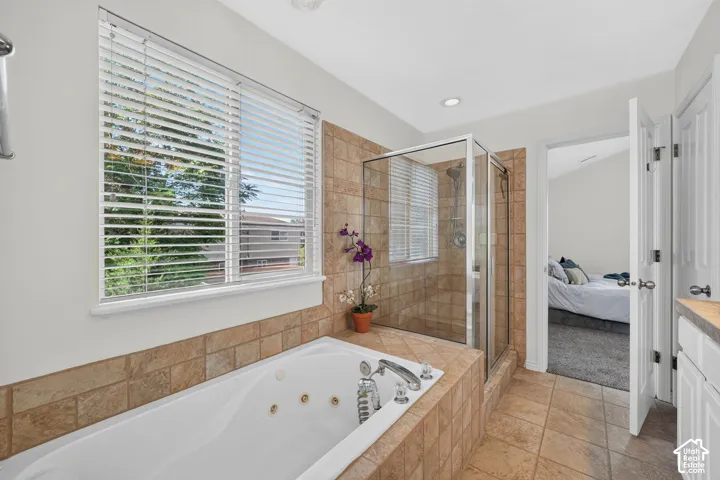 Soaking tub with jetted features, surrounded by tiled decking