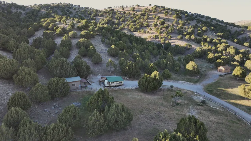 Hillside property featuring three distinct structures and extensive natural landscaping
