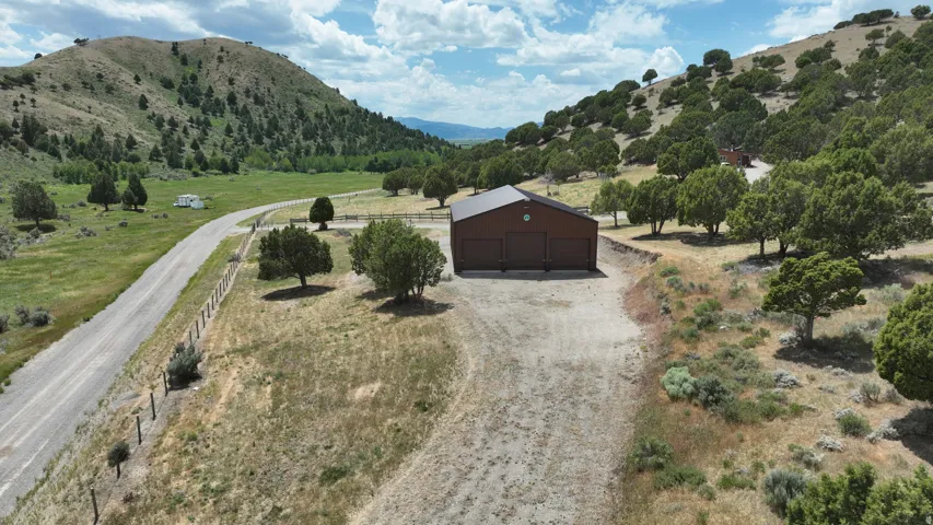Brown metal-sided barn with three garage doors