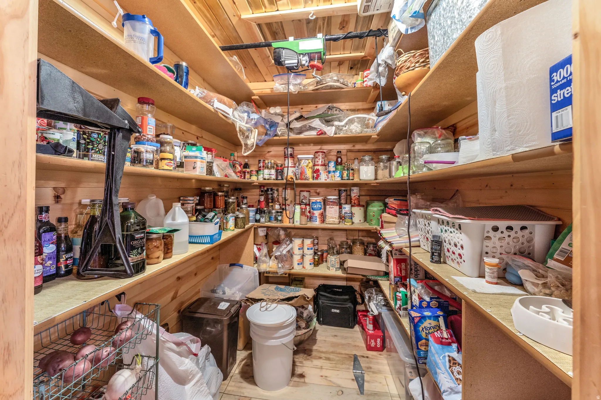 Spacious pantry featuring extensive wood shelving