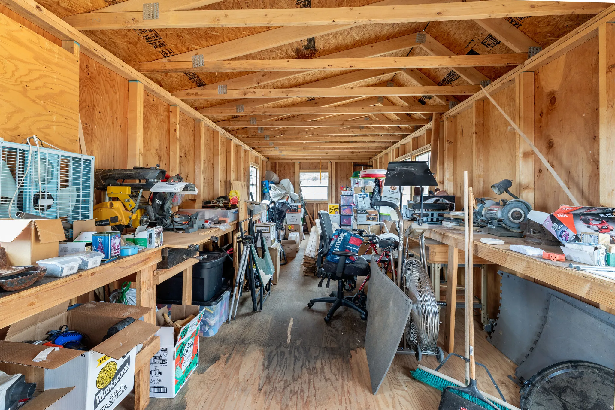 Interior space featuring exposed wood framing and plywood walls