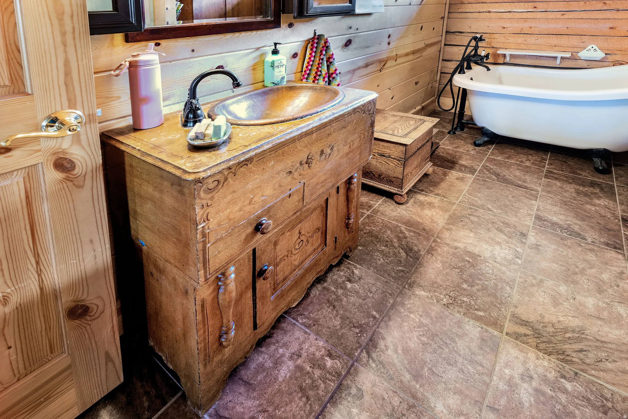 Antique wooden vanity with an integrated basin and dark-finish faucet