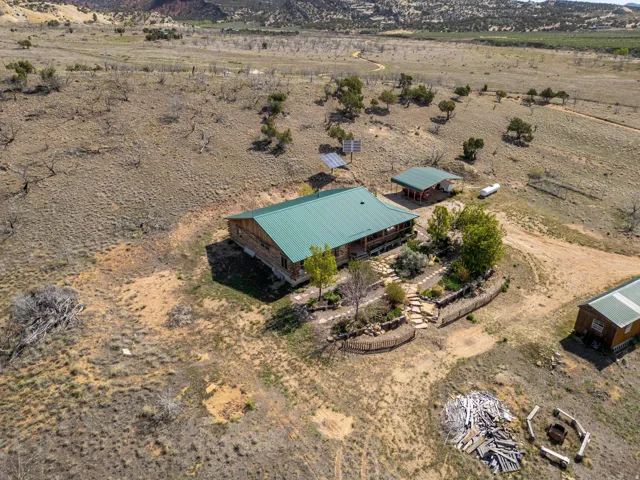 Ranch-style residence featuring a green metal roof and an expansive porch