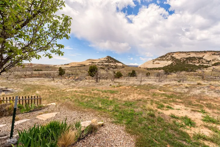 Expansive, undeveloped terrain featuring natural vegetation and distant hills
