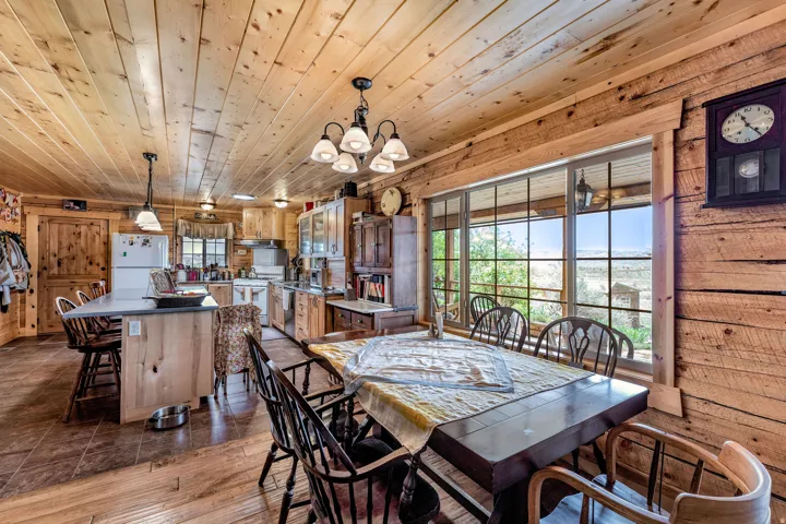 Open-concept kitchen with a central island and a dining area with a large multi-pane window