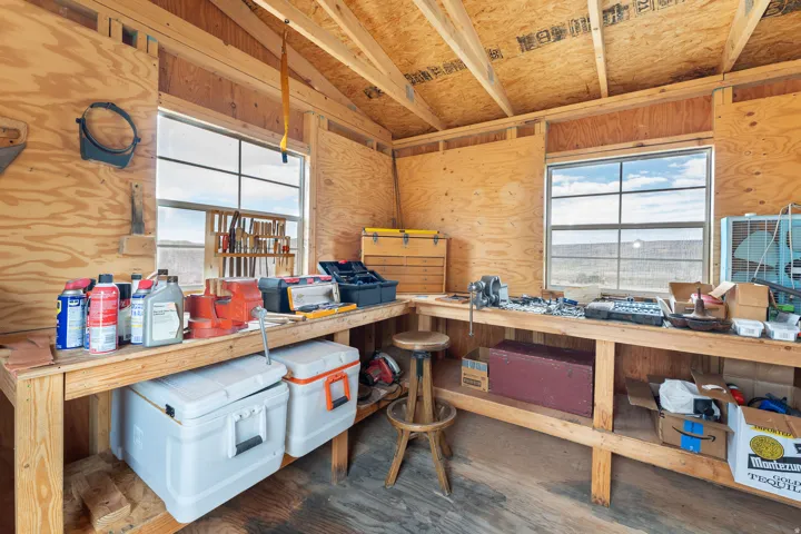 Workshop space featuring exposed wood framing and a plywood finish throughout