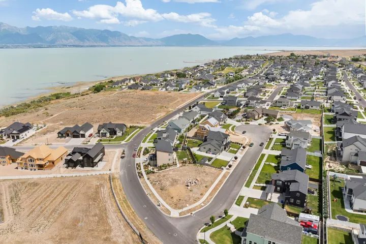 Expansive residential development featuring a waterside setting with distant mountains