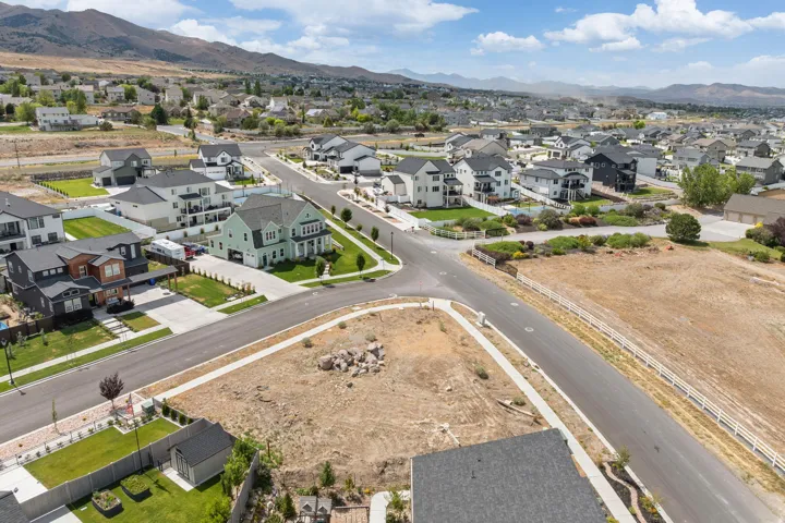 Expansive residential area featuring a variety of single-family homes, paved streets, and a mountain backdrop